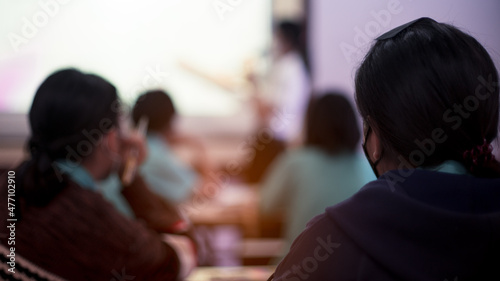 Students are studying in a classroom after lockdown with everyone wearing masks to prevent Covid-19