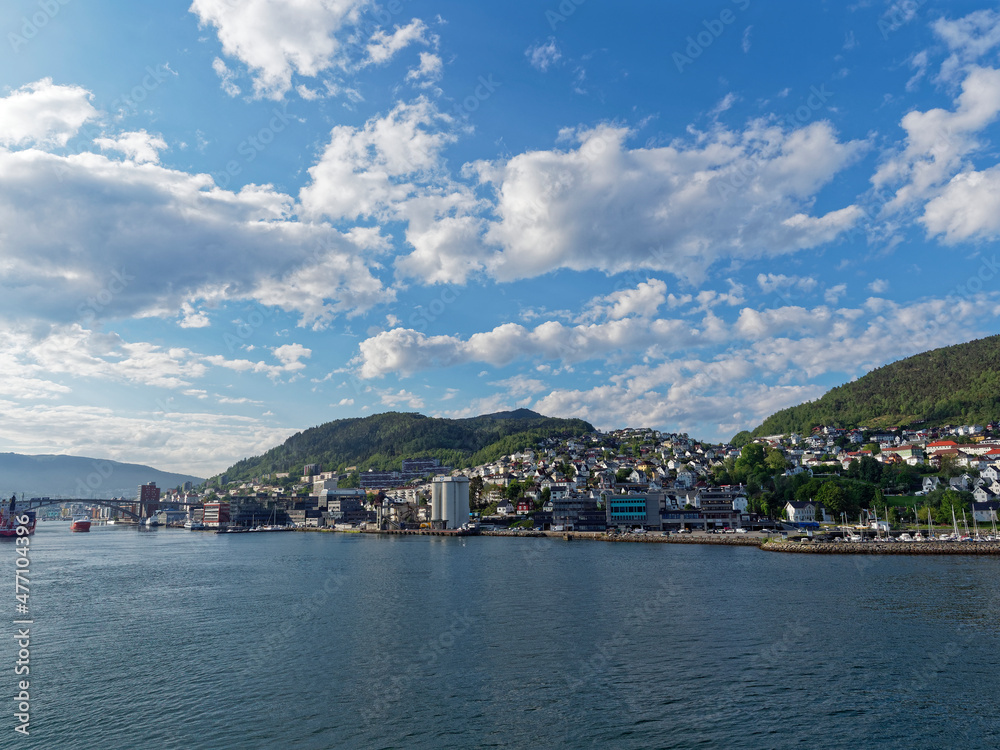 The Port of Bergen close to the City Centre and surrounded by Houses, Apartments, Offices and Commercial Buildings beneath the wooded Hillside.