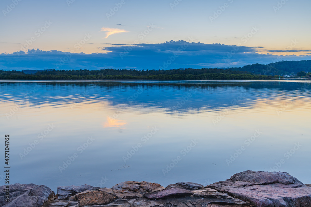 Sunrise waterscape with cloud reflections