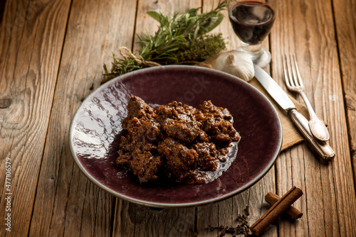 venison stew traditional italian recipe and glass of red wine