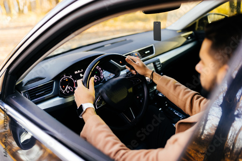 young asian man driving car on the road photo