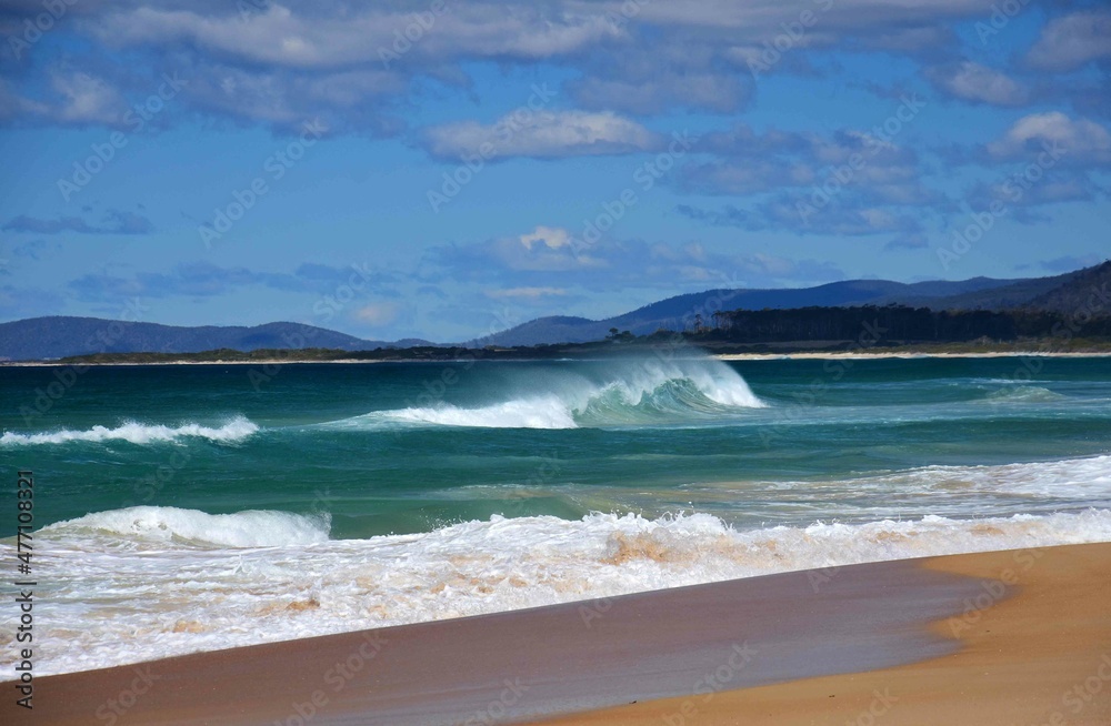 picturesque four mile creek  beach and surf, on the east coast of tasmania, australia, along the tasman highway