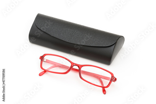 Red eyeglass and box on the white background.