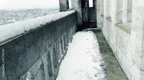 Panoramic aerial view of the Old Town district of Geneva and the Jet d'Eau fountain on a snowy day, from the top of the cathedral tower.