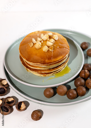 Stack of macadamia pancakes sprinkled with chopped nuts. Traditional Hawaiian dessert.