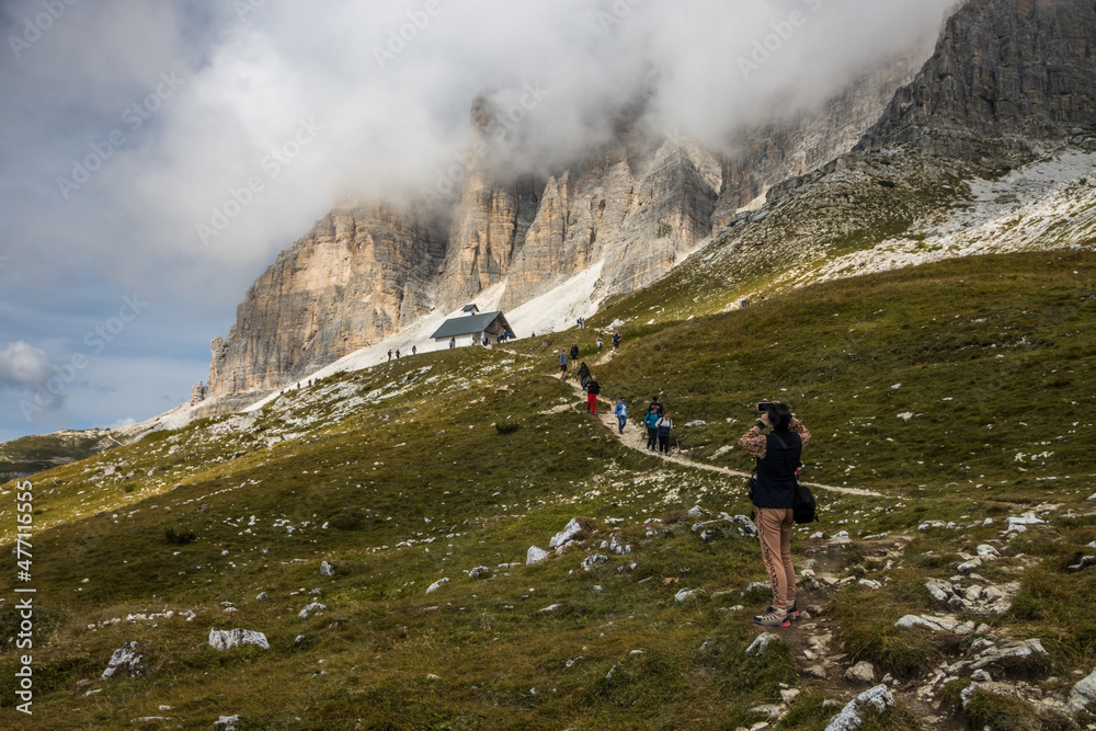 Clouds over mountain trail Tre Cime di Lavaredo in Dolomites in Italy