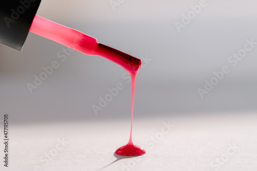 Close up of pink nail polish flow on white background with clipping path