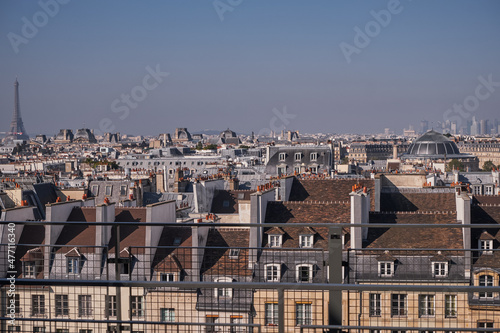 View of the Parisian Skyline with Eiffel Tower and Traditional Roofs and Chimneys from the Top of the Centre Pompidou in Paris, France photo