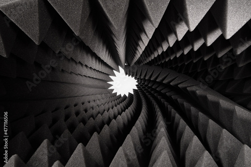 Abstract fractal background. Light hole in the roll triangular acoustic foam rubber. Studio sound proof foam pattern texture. Shallow depth of field	 photo