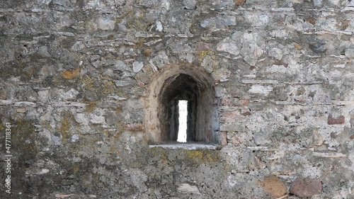 Arrowslit (Loophole) In The Stone Wall Of A Medieval Castle photo