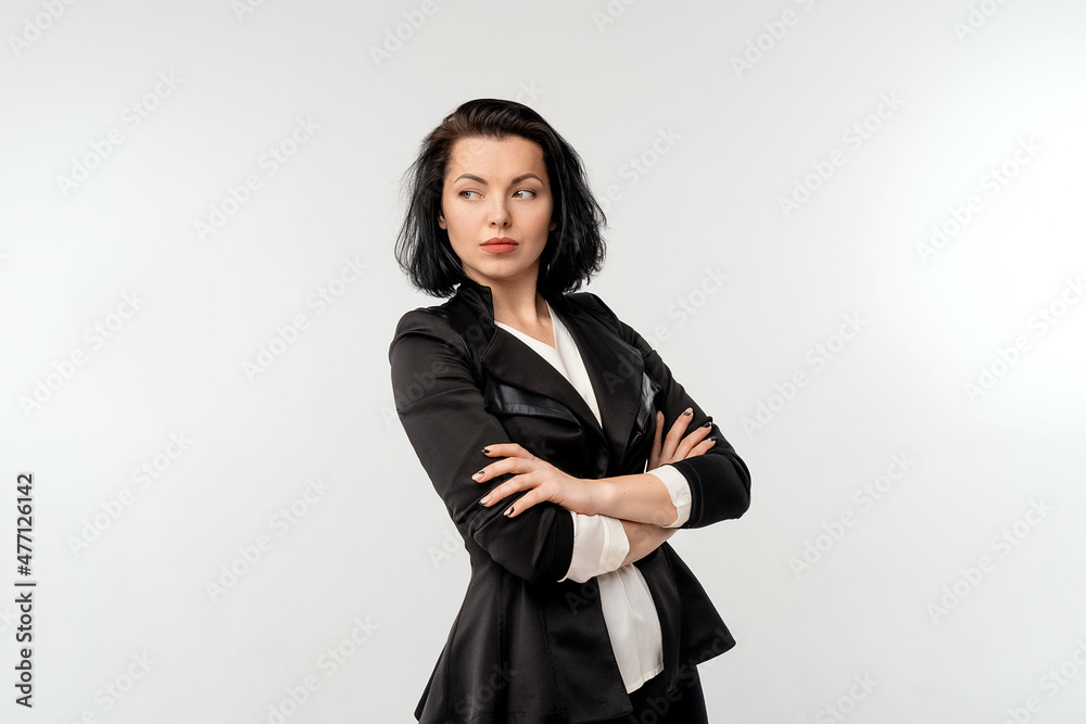 Confident young business woman with arms crossed, posing isolated over white background, wear black formal jacket white shirt. Achievement career wealth, business concept Confident young business woman with arms crossed, posing isolated over white background, wear black formal jacket white shirt. Achievement career wealth, business concept