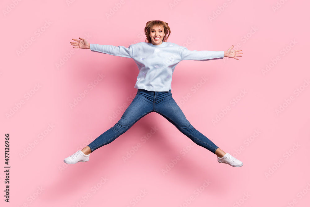Full length body size view of attractive cheerful girl jumping having fun isolated over pink pastel color background Full length body size view of attractive cheerful girl jumping having fun isolated over pink pastel color background