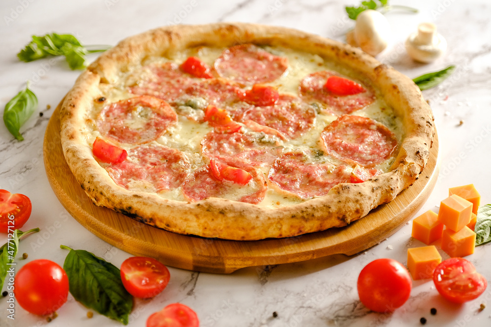 Appetizing, fresh pizza is on the table. Food from an Italian restaurant. Cooking pizza. Pizza ingredients. Appetizing, fresh pizza is on the table. Food from an Italian restaurant. Cooking pizza. Pizza ingredients.