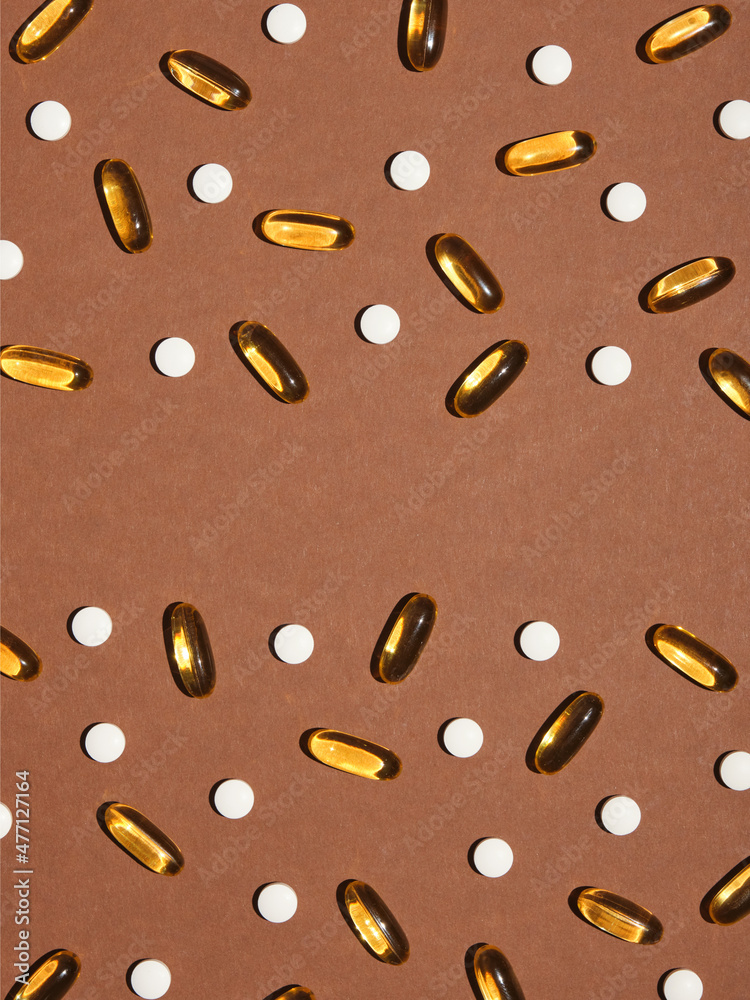 A lot of pills and vitamins scattered on the surface. Flat lay composition, copy space for text. Idea of health and medicine. A lot of pills and vitamins scattered on the surface. Flat lay composition, copy space for text. Idea of health and medicine.