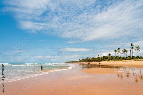 Tourists enjoying a sunny day in a wild tropical beach in Brazil