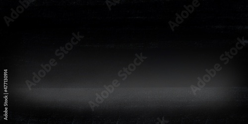 Fondo abstracto con textura en colores muy oscuros con base de suelo y reflejo o foco de luz. Recurso grafico con espacio para texto o imagen