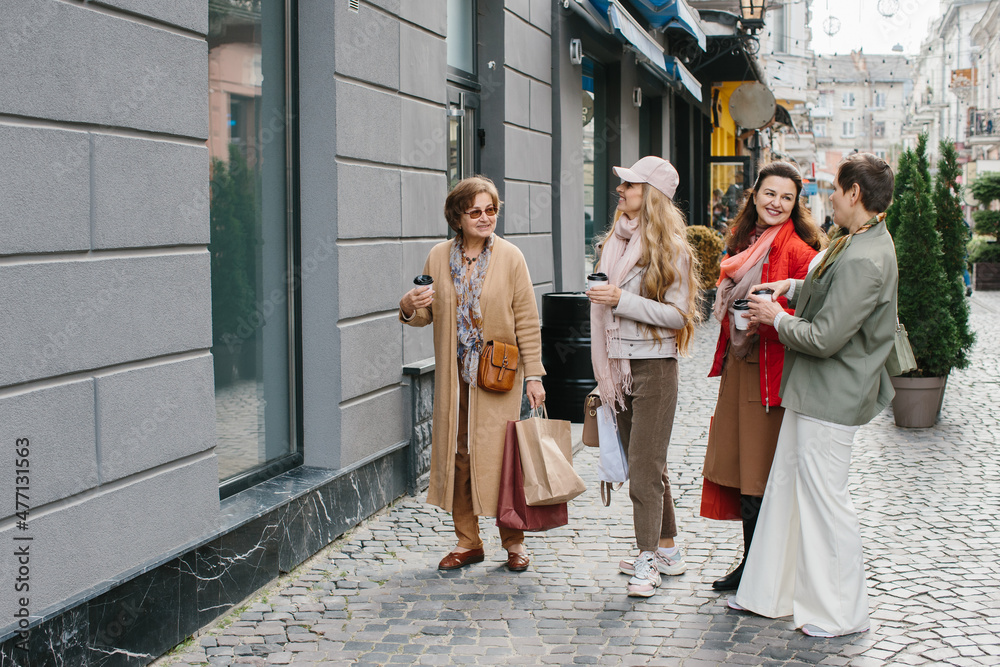 Older women, best friends have fun walking the streets of the city shopping. Older women, best friends have fun walking the streets of the city shopping.