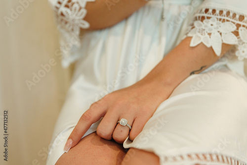 The bride shows off her diamond wedding ring on her wedding day The beautiful bride shows a ring The girl in wedding robe shows an engagement ring on her finger Happy wedding day Pre-wedding party 