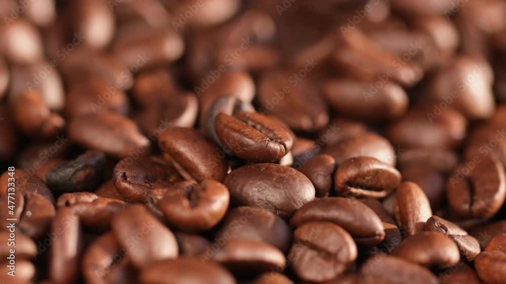 Close up of seeds of coffee. Fragrant coffee beans are rotate Close up of seeds of coffee. Fragrant coffee beans are rotate