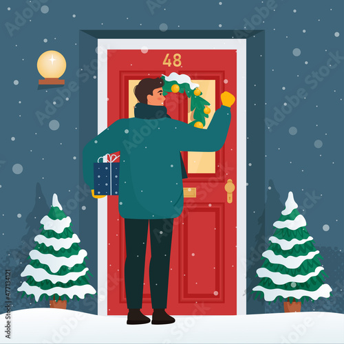 Man with a gift knocks on the door. Christmas or New Year's Eve, snowy weather. Cute vector illustration in flat style