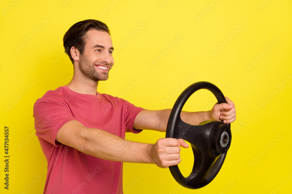 Photo of brunet nice millennial guy drive auto wear red t-shirt isolated on yellow color background Photo of brunet nice millennial guy drive auto wear red t-shirt isolated on yellow color background