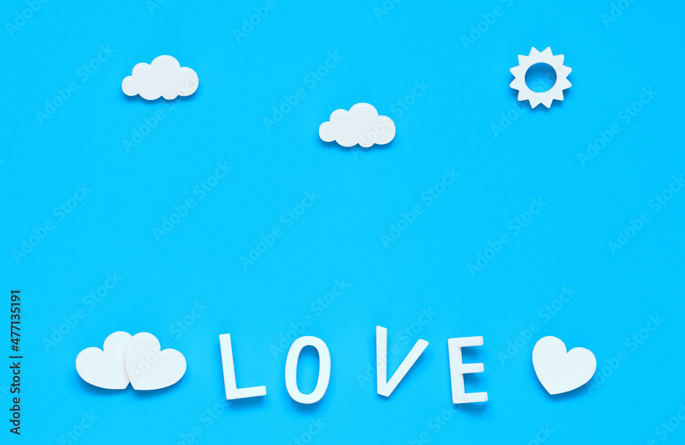 love, a word made of white letters. white hearts, clouds and sun on a blue background love, a word made of white letters. white hearts, clouds and sun on a blue background
