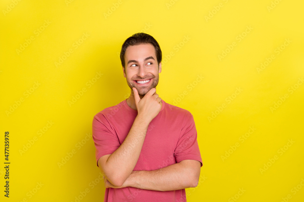 © deagreez - Photo of clever guy finger chin look empty space dream wear pink t-shirt isolated yellow color background