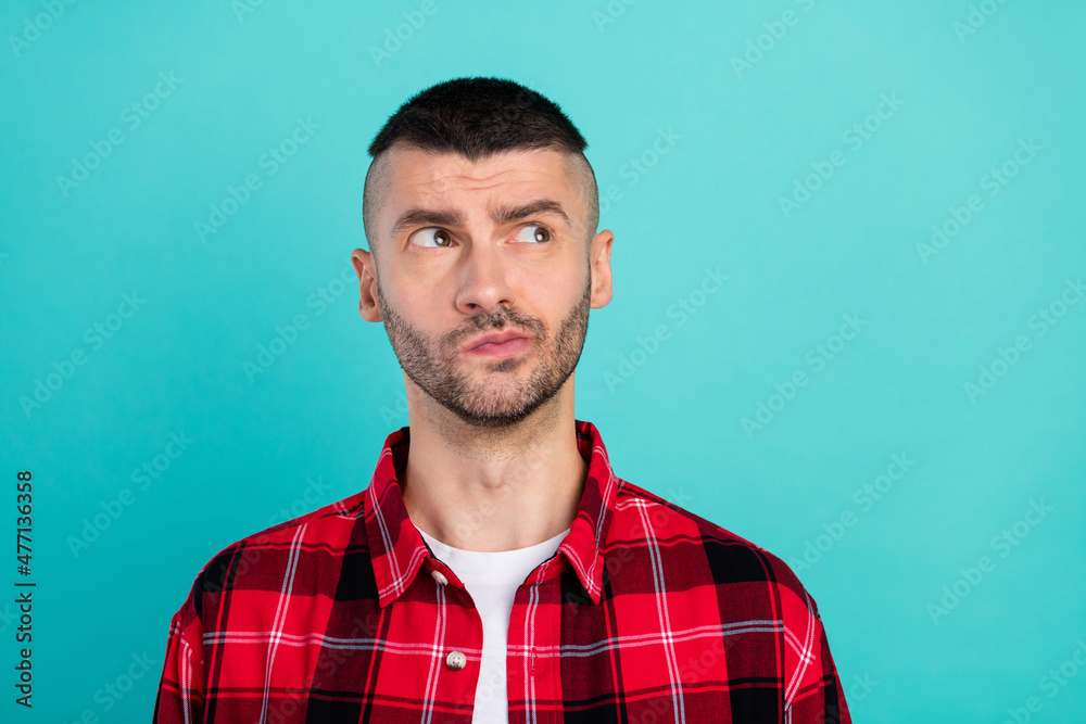 Photo of young minded thoughtful man look empty space think brainstorm serious isolated on teal color background Photo of young minded thoughtful man look empty space think brainstorm serious isolated on teal color background