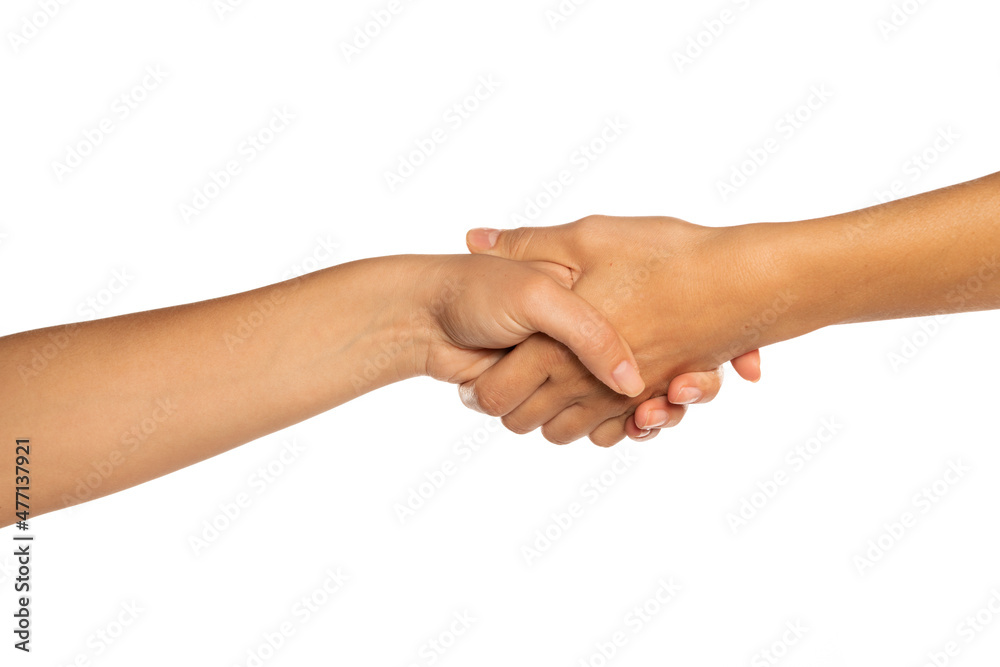Two female hands shaking, isolated on white background.
