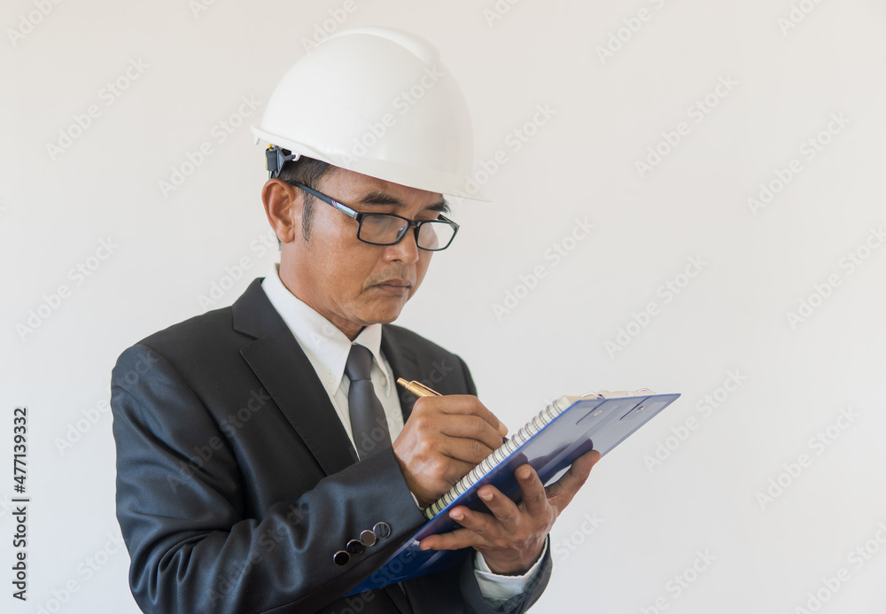 Business man writing note on paperwork on white background 