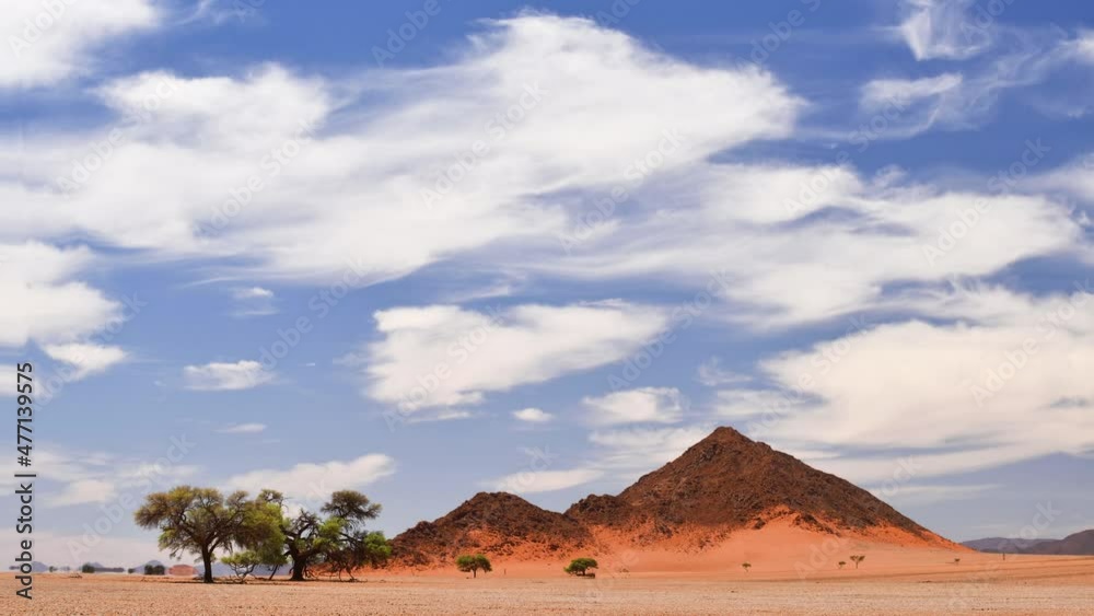 The Namib Desert with reddish sand and the deep blue sky with white ...