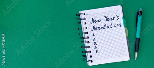 banner with New Year's resolutions concept. New Year's resolutions on a green background. Flat lay.