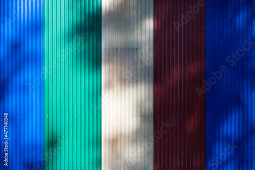 Vertical structure made with fiber cement sheets of various colors, with shadows