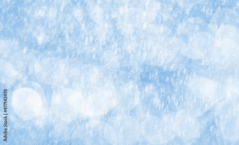 Fototapeta premium Bokeh lights with snowfall in light blue tone