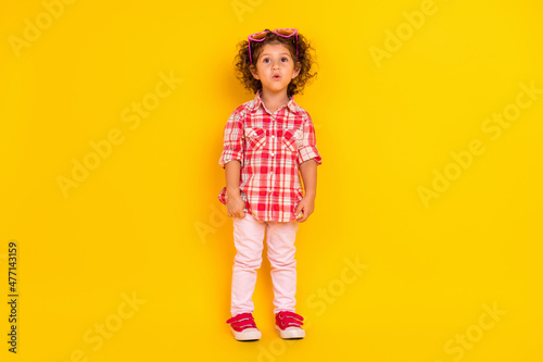 Photo of funny impressed schoolgirl wear plaid outfit pink heart glasses isolated yellow color background
