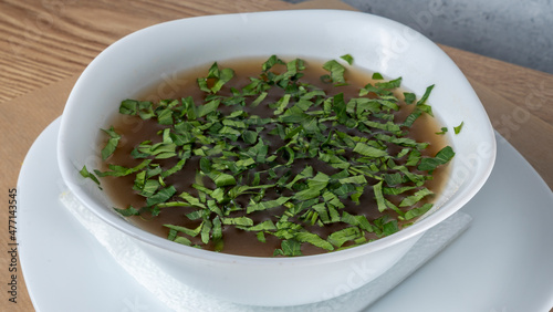 Close-up view of mushroom soup with green onions and champignons. Healthy food concepts.