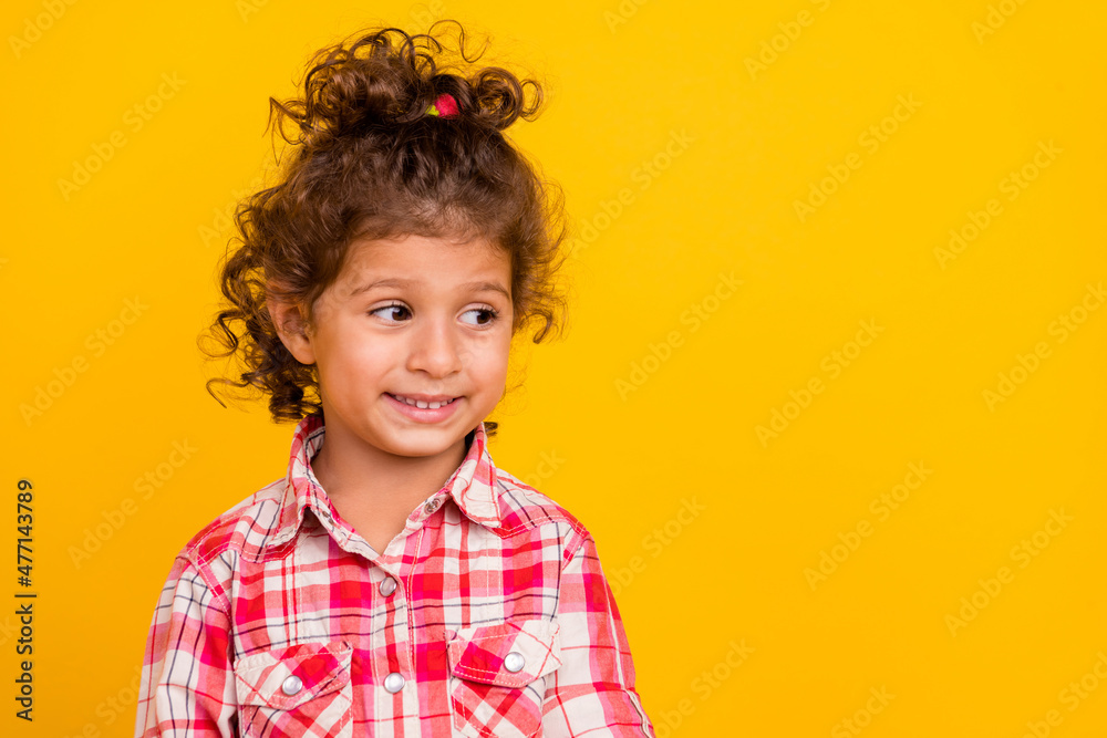 Photo of cute little brunette girl look empty space wear red shirt isolated on yellow color background Photo of cute little brunette girl look empty space wear red shirt isolated on yellow color background