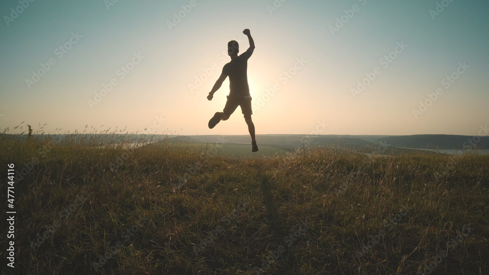 The happy man jumping on a mountain top The happy man jumping on a mountain top