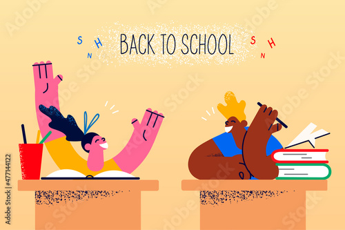 Happy children at desk back to school 