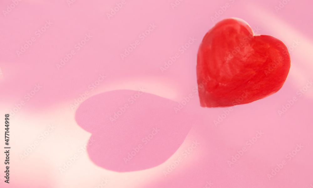 shadow form heart shape on pink paper .Love, and Valentine's Day shadow form heart shape on pink paper .Love, and Valentine's Day