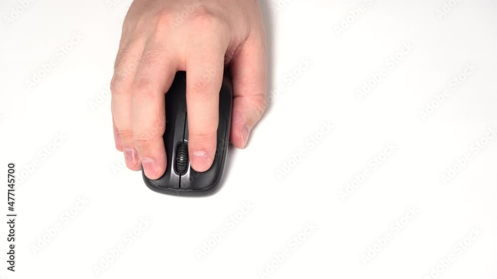 Hand with Wireless Computer Mouse Moves and Clicks. Top View Shot. Close-up. Blue background Hand with Wireless Computer Mouse Moves and Clicks. Top View Shot. Close-up. Blue background