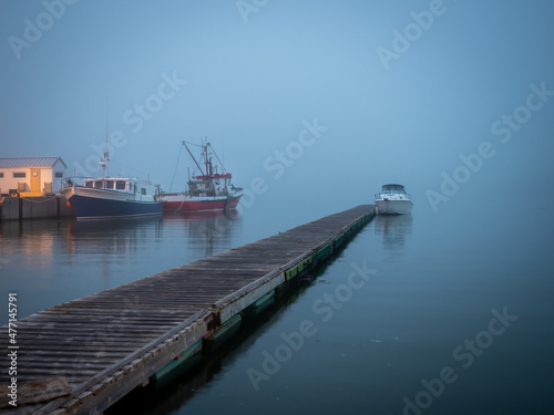 Boat on the St-Laurence river at blue hour at Trois-Pistol harbour in Gaspesie © Daniel