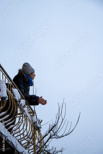Woman staing on the top of stairs. Mountains background.