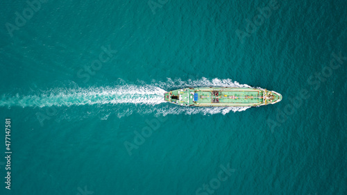 Oil ship tanker full speed with beautiful wave and splash water in line of transportation from refinery on the sea. © SHUTTER DIN