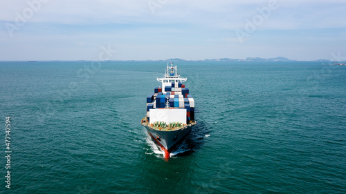 angle view in front container ship full speed in green sea, business and industry transportation import export international by container ship open sea