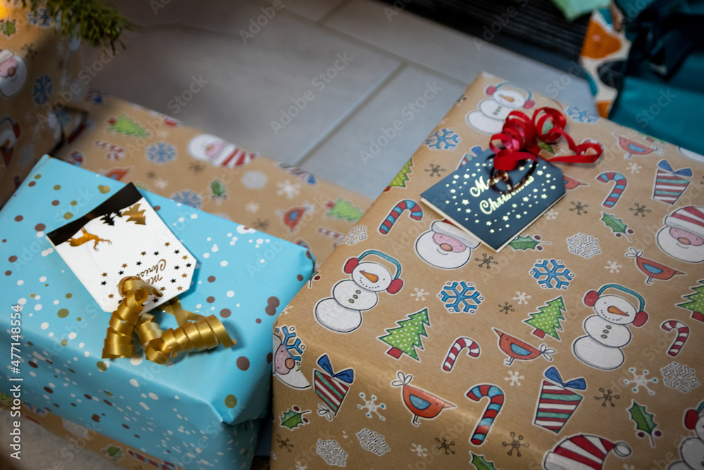 Fototapeta premium Festive wrapped Christmas gifts and Christmas presents under the xmas tree shows decorative unboxing event with traditional celebration of handmade winter season for sparkling children eyes beauty