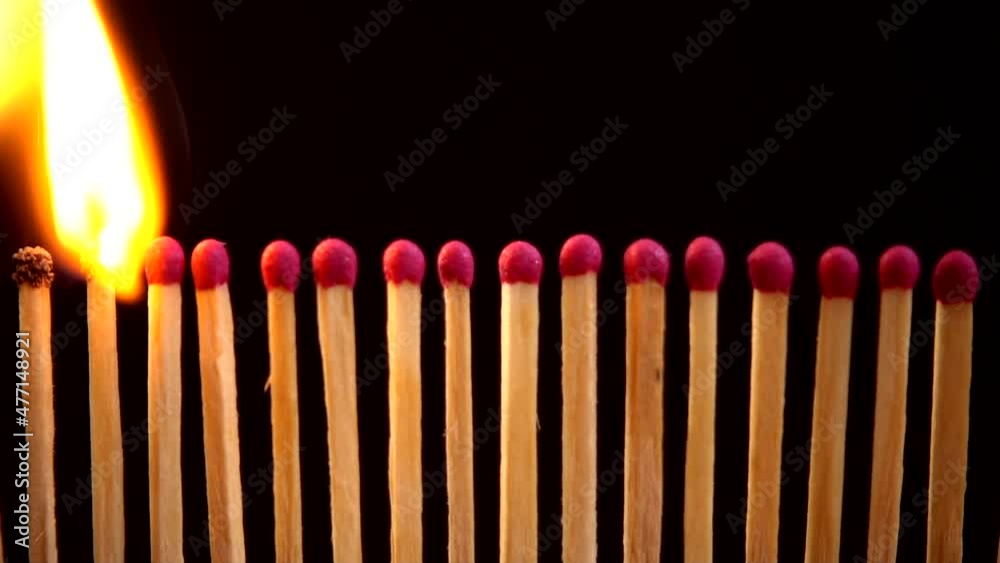 Burning matches on a black background. Slow motion. Burning matches on a black background. Slow motion.