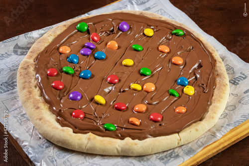 Chocolate pizza with cheese and m&m on top © Klinsmann
