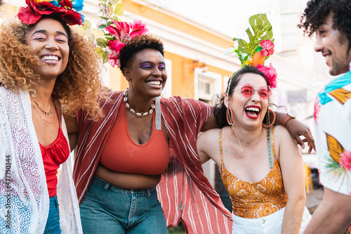 Carnival day in Brazil, woman and friends dance at street party. People in costumes celebrate Brazilian Carnaval photo