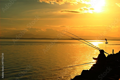 Italy, Umbria, Passignano: Fisherman in Trasimeno Lake.